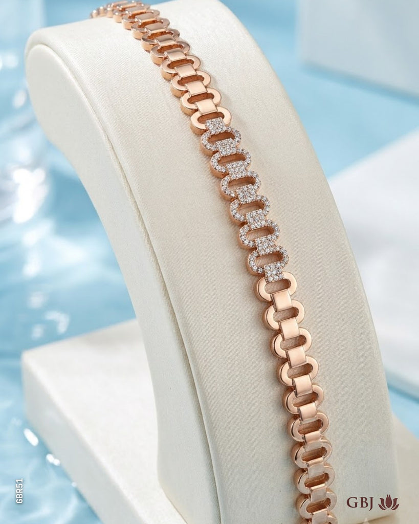 A rose gold chain bracelet with alternating solid and pavé-set diamond links, displayed on a cream-colored jewelry bust against a light blue background.